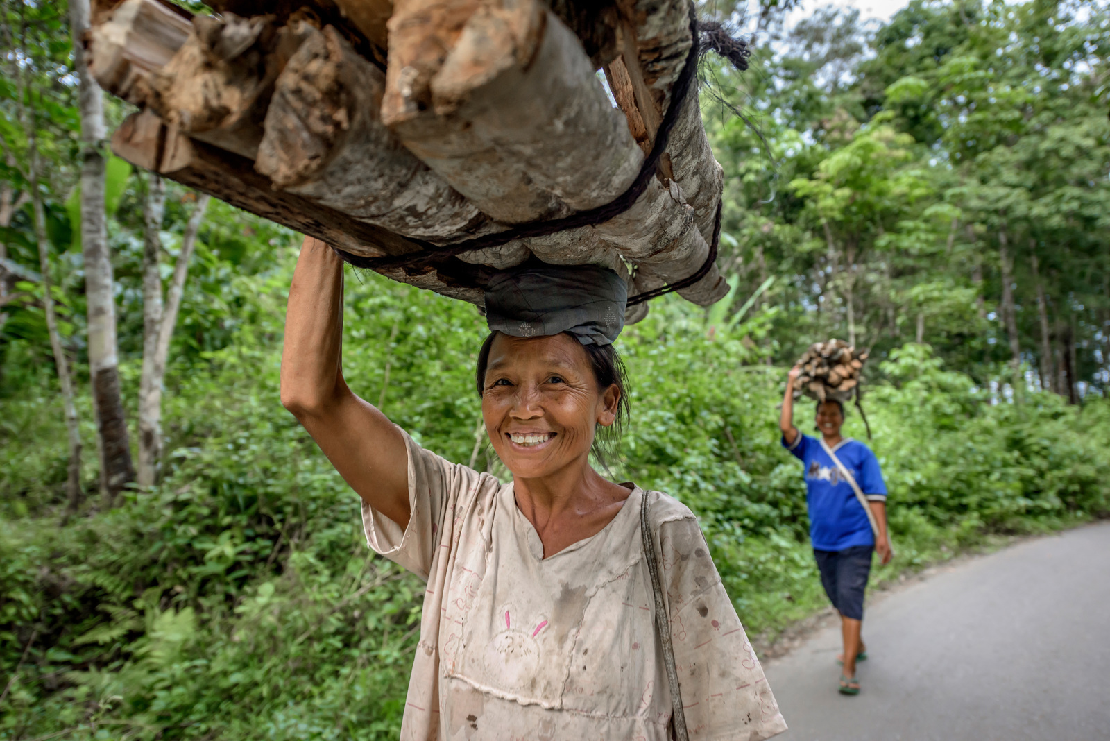 Women in Aek Banir village near Batang Gadis National Park, Mandailing Natal, North Sumatra, carry home firewood from the forest on their heads